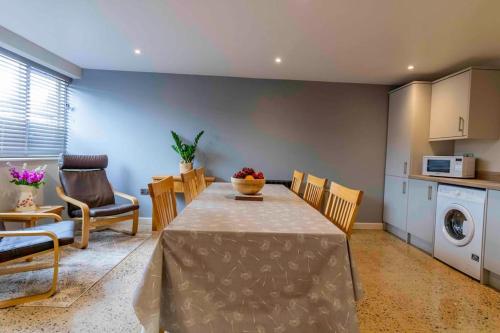 a kitchen and dining room with a table and chairs at Wensleydale Halls in Leyburn