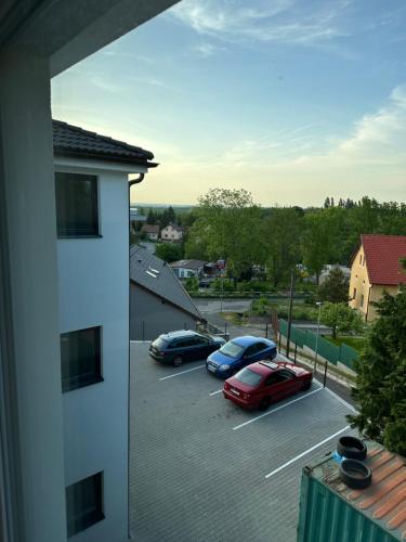 a view of cars parked in a parking lot at Apartmán byt 75m2 klid příroda pro rodinu in Prague