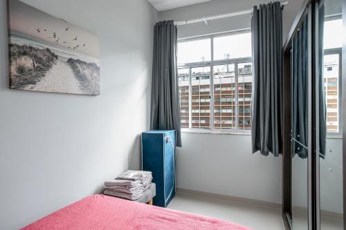 1 dormitorio con cama y ventana grande en Copa Sky Apartments, en Río de Janeiro