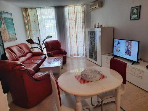 a living room with a couch and a table at Apartment in Sunny beach, Complex Sun Village, 80 qm, 2 bedrooms & living room near to the beach, SWIMMING POOL, garden in Sunny Beach