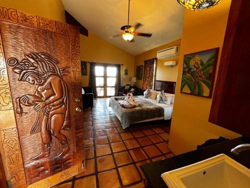 a room with a bed and a wall with a carving at Captain Morgan's Retreat in San Pedro