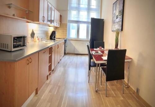 a kitchen with a table and a dining room at Super Old Town in Prague