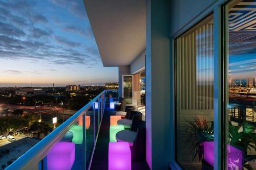 a balcony with a view of the city at night at The Karol Hotel, St. Petersburg Clearwater, a Tribute Portfolio Hotel in Clearwater