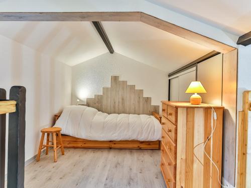 a bedroom with a bed and a table and a stool at Vertmarines 165 in Saint-Jean-de-Monts