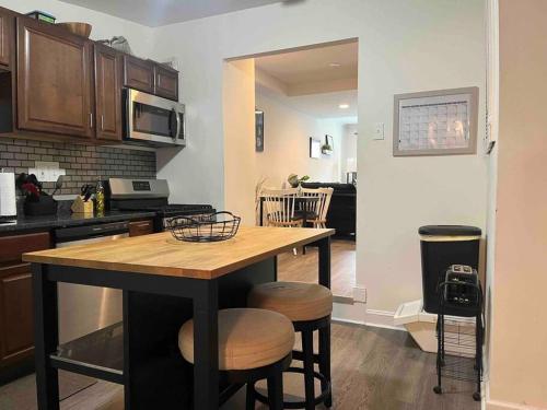 a kitchen with a table and stools in a room at A Sports Fan Getaway in Baltimore