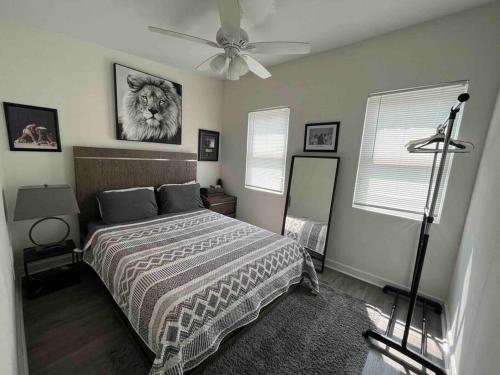 a bedroom with a bed and a ceiling fan at A Sports Fan Getaway in Baltimore
