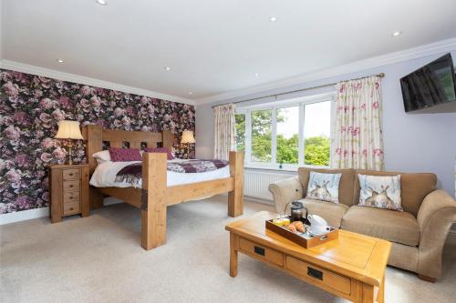 a bedroom with a bed and a couch at The Lodge in Middlesbrough