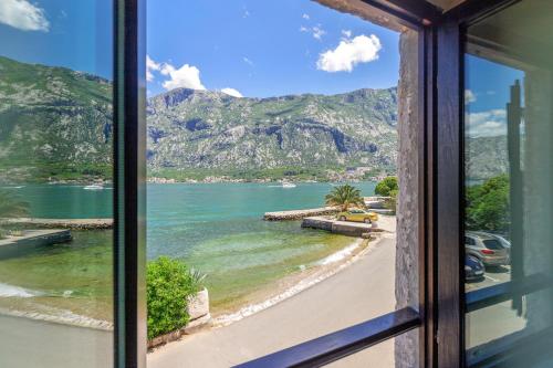 a view of a beach from a window at Apartments Saxo in Kotor