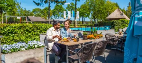 a man and a woman sitting at a table at De Stamper - De Wije Werelt in Otterlo