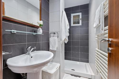 a small bathroom with a sink and a toilet at Apartments Saxo in Kotor