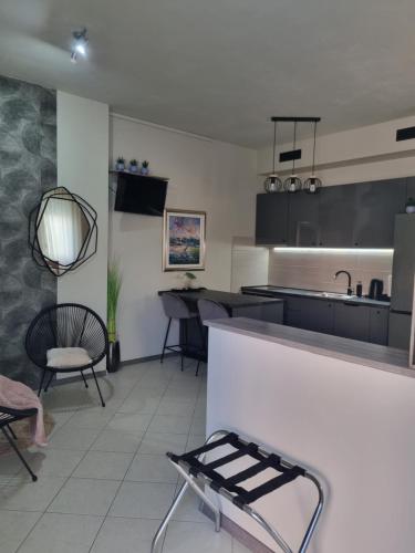 a kitchen with a counter and chairs in a room at OnlyStudio with free parking in Zadar