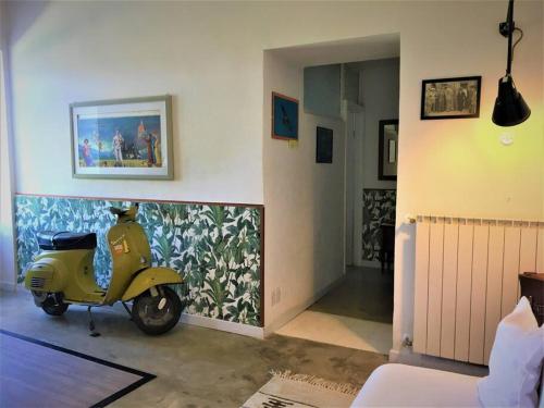 a yellow scooter parked in a room with a wall at Welcome in Toscana in Polcanto