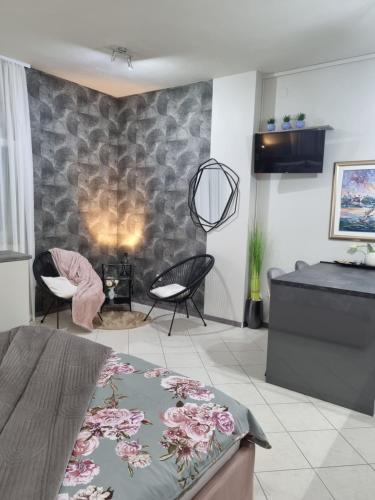 a living room with a couch and chairs in a room at OnlyStudio with free parking in Zadar