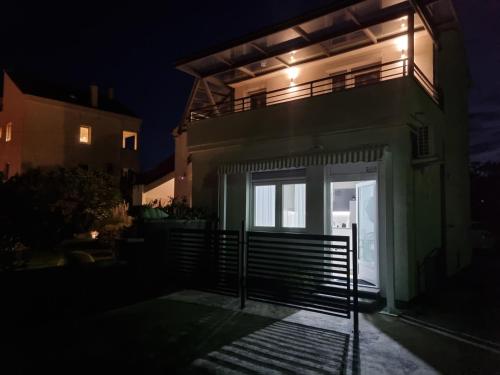 a house lit up at night with a garage at OnlyStudio with free parking in Zadar