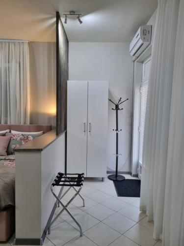 a bedroom with a bed and a chair in it at OnlyStudio with free parking in Zadar
