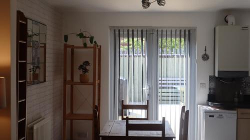 a kitchen with a table and a sliding glass door at Urban Escape Glasgow Green Free Parking 20min walk to City Center in Glasgow