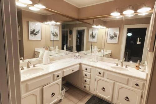 a bathroom with two sinks and a large mirror at The Hooper House in Grenada