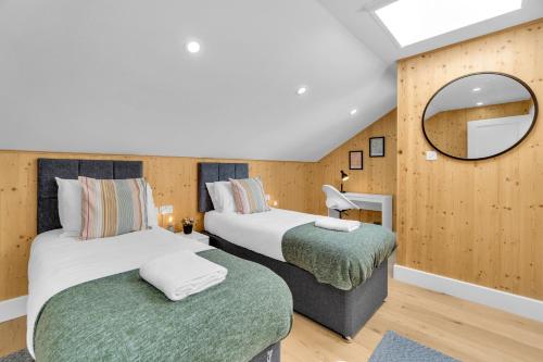 a hotel room with two beds and a mirror at Green Mews 2 with Free Parking - By My Getaways in Brighton & Hove