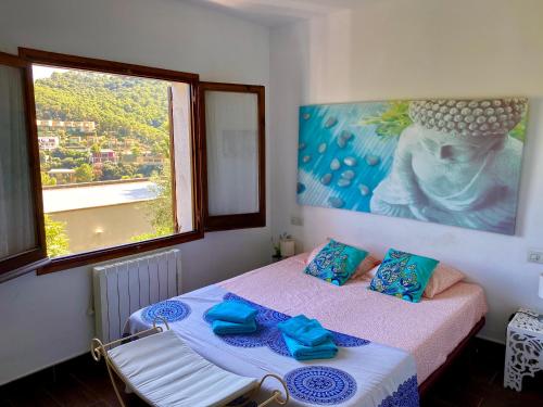 a bedroom with two beds and a large window at Villa Buda Begur in Begur