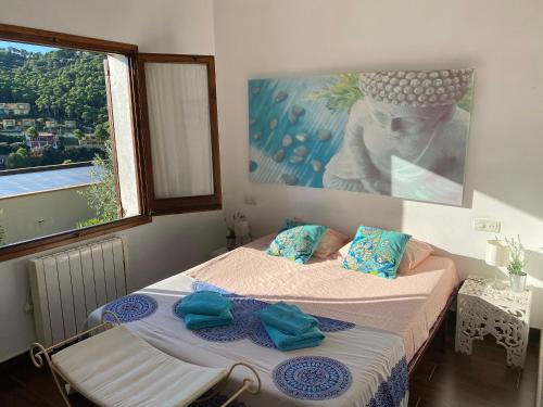 a bedroom with two beds and a large window at Villa Buda Begur in Begur