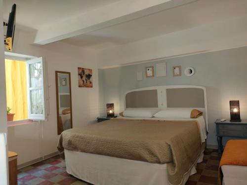 a bedroom with a large bed and a window at essential in Palermo