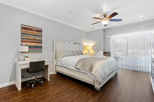a bedroom with a bed and a desk and a ceiling fan at 629 Walk to Restaurants Close to Golf and Spa Luxury Inside the gates in Encinitas