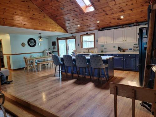 a kitchen and living room with a table and chairs at Legend Rock Lodge in South Kingstown