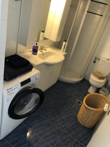 a bathroom with a washing machine and a sink at Pounta Beach House in Sounio