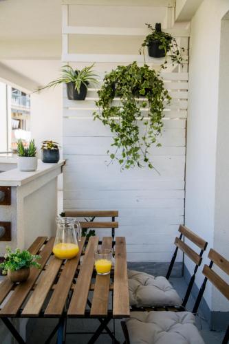 a wooden table with two glasses of orange juice at Apartments Toni in Split