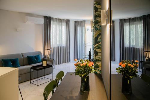 a living room with a couch and a table with flowers on it at Apartments Toni in Split