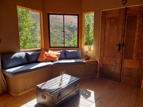 a living room with a couch and two windows at CASAS AMANCAY - Alcohuaz in Alcoguaz