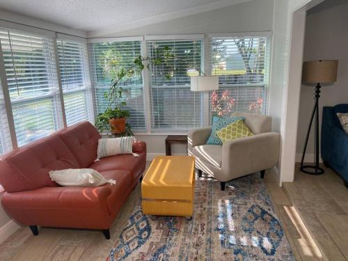 a living room with a couch and a chair at Rock Ridge I. Private and close to everything. in Vero Beach