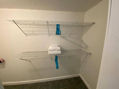 a bathroom with white shelves and a towel at Rock Ridge I. Private and close to everything. in Vero Beach