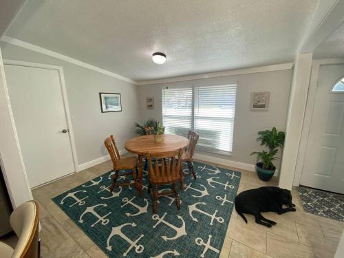 a black dog laying around a dining room table at Rock Ridge I. Private and close to everything. in Vero Beach