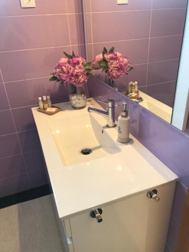 a bathroom with a sink and a mirror at Casa do Pereiro in Vieira do Minho