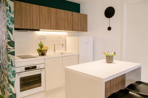 a kitchen with white cabinets and a white counter top at Apartments Toni in Split