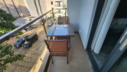a balcony with a table and chairs on a balcony at Embassy Access Golf Apartment in Kigali