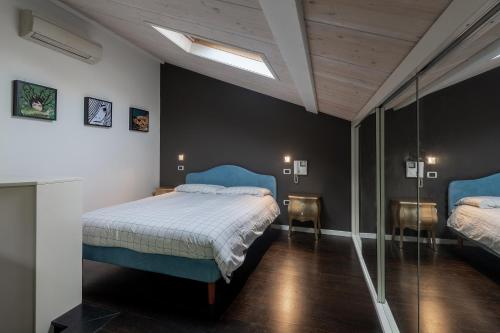 a bedroom with two beds with blue headboards at Casa Angelina Pesaro Centro Mare in Pesaro