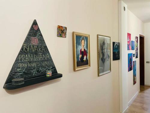 a group of pictures on a wall in a museum at Mandala Maison - Zen Oasis in Marone