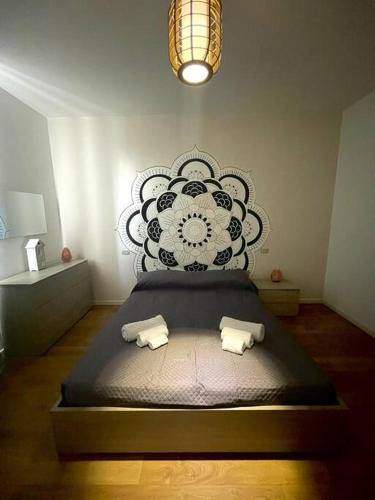 a bed in a room with a black and white wall at Mandala Maison - Zen Oasis in Marone