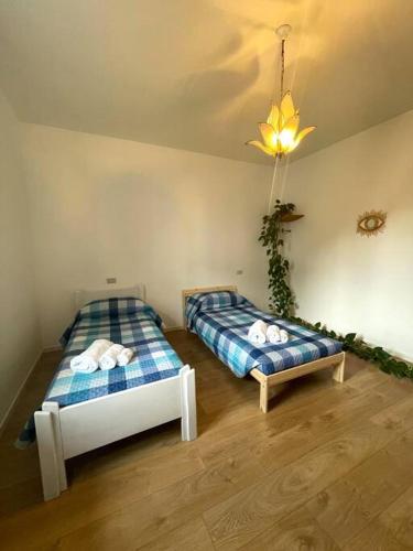 a bedroom with two beds and a ceiling at Mandala Maison - Zen Oasis in Marone