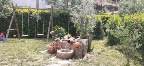 a garden with a swing and a playground at Villa Garden & Pool - Alojamentos in Celorico de Basto