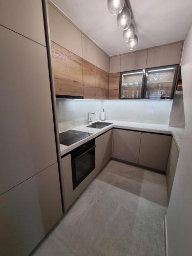 a kitchen with a sink and a stove at Villa Maslina in Ljubuški