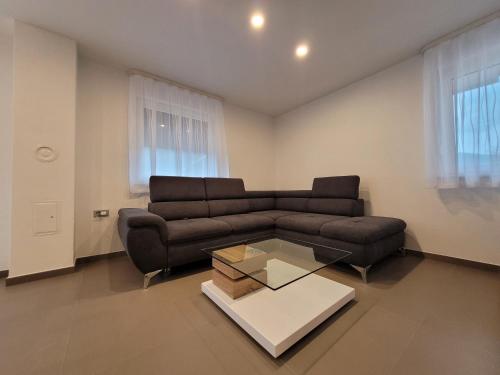 a living room with a couch and a coffee table at Apartment river Nadiža Podbela in Podbela