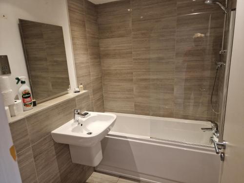 a bathroom with a sink and a tub and a toilet at The Bank in Lewes