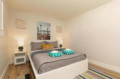 a bedroom with a bed with two pillows on it at 106B New Renovation! Huge Patio with Harbor View in Oceanside