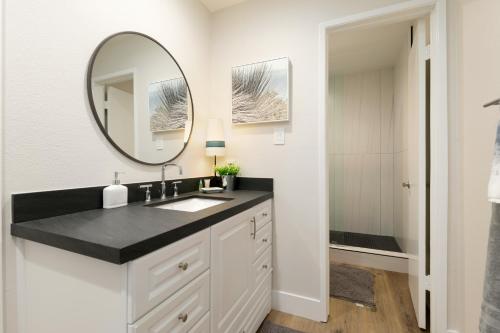 a bathroom with a sink and a mirror at 106B New Renovation! Huge Patio with Harbor View in Oceanside