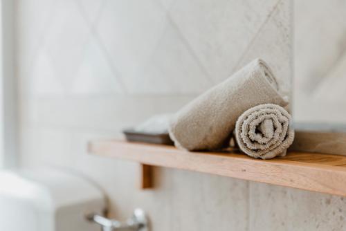 a towel on a wooden shelf in a bathroom at Trullo Della Murgia - Villa in Castel del Monte