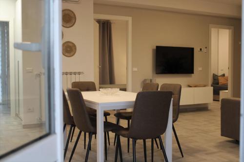 a dining room with a white table and chairs at GF Holiday Suite 3 in Varazze