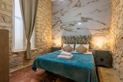 Un dormitorio con una cama azul con una pintura en la pared en Casa Alicantina, en Alicante